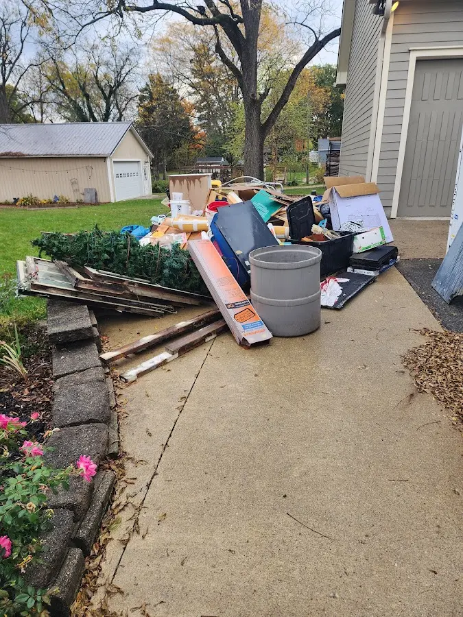 Dumpster being loaded with debris for Commercial Dumpster Rental in Kirksville